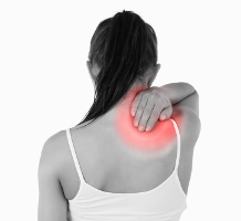 Woman massaging shoulder with highlighted pain